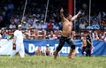 A wrestler celebrates victory on the final day of competition at the Kirkpinar Turkish Oil Wrestling Festival in Edirne in Royalty Free Stock Photo