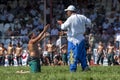 A wrestler pleads with a referee at the Elmali Turkish Oil Wrestling Festival in Turkey. Royalty Free Stock Photo