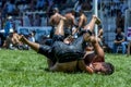 A wrestler tosses his opponent onto his back during competition at the Elmali Turkish Oil Wrestling Festival in Elmali in Turkey. Royalty Free Stock Photo