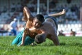 Wrestlers battle at ground level during competition at the Elmali Turkish Oil Wrestling Festival in Elmali in Turkey.