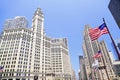 Wrigley Building and Tribune Tower on Michigan Avenue with American flag on the foreground in Chicago Royalty Free Stock Photo