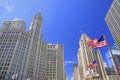 Wrigley Building and Tribune Tower on Michigan Avenue with Illinois flag on the foreground in Chicago Royalty Free Stock Photo