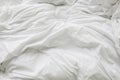 Wrinkle messy blanket and white pillow in bedroom after waking up in the morning, from sleeping in a long night Royalty Free Stock Photo