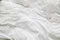 Wrinkle messy blanket and white pillow in bedroom after waking up in the morning, from sleeping in a long night Royalty Free Stock Photo