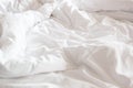 Wrinkle messy blanket and white pillow in bedroom after waking up in the morning, from sleeping in a long night, details of duvet Royalty Free Stock Photo