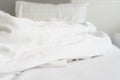 wrinkle messy blanket and white pillow in bedroom after waking up in the morning, from sleeping in a long night, details of duvet Royalty Free Stock Photo