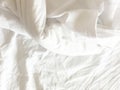 wrinkle messy blanket and white pillow in bedroom after waking up in the morning, from sleeping in a long night, details of duvet Royalty Free Stock Photo