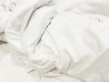 wrinkle messy blanket and white pillow in bedroom after waking up in the morning, from sleeping in a long night, details of duvet Royalty Free Stock Photo