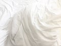 wrinkle messy blanket and white pillow in bedroom after waking up in the morning, from sleeping in a long night, details of duvet Royalty Free Stock Photo