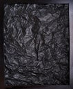 wrinkled black papper in black frame background Royalty Free Stock Photo
