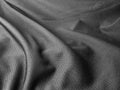 Wrinkled black polyester fabric close up