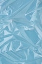 Wrinkled cling film, blue vinyl abstract background.