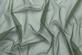 wrinkled, compressed fabric mesh tulle green on white isolated background close-up. background for your design Royalty Free Stock Photo