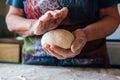 Wrinkled grandmothers hands holding and kneading fresh bread dough