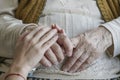 Wrinkled hand holding a younger hand Royalty Free Stock Photo