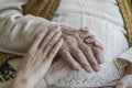 Wrinkled hand holding a younger hands Royalty Free Stock Photo