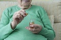 Wrinkled hands of a senior woman holding vitamin pills Royalty Free Stock Photo