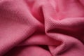 Wrinkled pink micro-ribbed jersey, soft fabric wavy background