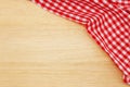 Wrinkled red gingham fabric on rustic light brown wood background. Royalty Free Stock Photo