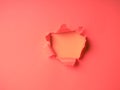 Wrinkled ripped torn red paper with hole in center background texture poster backdrop empty space