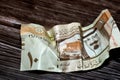 Wrinkled 10 Saudi Riyals cash bill banknote isolated on a wooden background