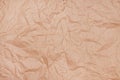 Wrinkled texture of crumpled brown craft paper as background Royalty Free Stock Photo