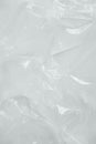 Wrinkled transparent plastic texture on a white background. Transparent packaging film. Top view. Copy, empty space for text