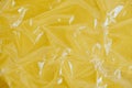 Wrinkled transparent plastic texture on an yellow background. Transparent cellophane texture on an yellow backing. Top view. Copy