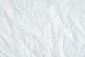 Wrinkled white cotton fabric texture background, wallpaper