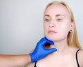 A cosmetologist prepares the patient for surgery: contour plastics of the neck, mesotherapy or botulinum therapy. Wrinkles and Royalty Free Stock Photo