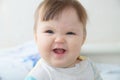 Wrinkling funny infant baby portrait, happy smiling child face expressing emotion Royalty Free Stock Photo