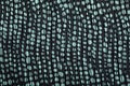 Wrinkly dotted black and turquoise cloth for background Royalty Free Stock Photo