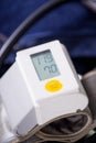 Wrist blood pressure monitor showing normal blood pressure, medical concept