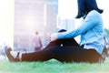 Wrist hand pain women sit on the green grass in the playground on sunset, city lifestyle concept Royalty Free Stock Photo