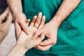 Wrist massage. A male massage therapist puts pressure on a sensitive point on a womans hand Royalty Free Stock Photo