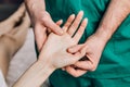 Wrist massage. A male massage therapist puts pressure on a sensitive point on a womans hand