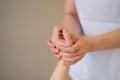 Wrist massage. massage therapist puts pressure on a sensitive point on a woman& x27;s hand. Physiotherapist massaging her
