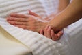 Wrist massage. massage therapist puts pressure on a sensitive point on a woman& x27;s hand. Physiotherapist massaging her