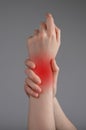 Wrist pain. Painful hand with red spot closeup. Sprain, fracture. Arthritis, office syndrome. Health care, medicine Royalty Free Stock Photo