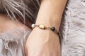 wrist wearing brass golden bracelet with mineral stone