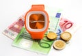 Wristlet watch with banknotes and coins