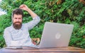 Write article for online magazine. Bearded hipster laptop surfing internet. Man looking for inspiration. Reporter Royalty Free Stock Photo