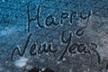 Write Happy New Year on the snow, the snow on iron background, inscription,