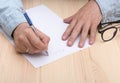 write a letter. In the hands of a man is a ballpoint pen and he writes a letter. Royalty Free Stock Photo