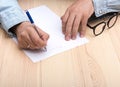 write a letter. In the hands of a man is a ballpoint pen and he writes a letter. Royalty Free Stock Photo