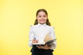 Write note to remember. Child school uniform smart kid happy make note. Girl happy face make note about idea yellow Royalty Free Stock Photo