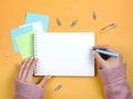 Write thoughts and ideas in a clean white notebook on an orange background