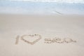 Write the word I Love Sea with wave on the beach. Royalty Free Stock Photo