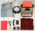 writer is going on a journey - typewriter, notepad, clothes, headphones, camera and glasses