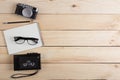 Writer, journalist or traveler desk - tape recorder, notepad and photo camera on the wooden background Royalty Free Stock Photo